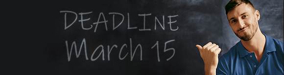 A teacher points over his shoulder at words on the chalkboard reading Deadline March 15.