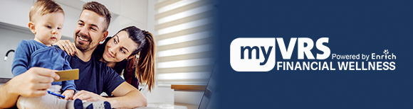 A couple smiles at their toddler son seated on the kitchen counter and staring down at the laptop computer in front of the family. The man holds a credit card in his right hand. To their right is the VRS Financial Wellness logo.