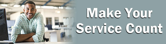 Decorative. A man leans on a desk with a large office in the background next to text reading make your service count.