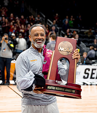 Kenny Brooks, Coach of Virginia Tech Women's Basketball hold the NCAA Seattle Regional 2023 Championship trophy